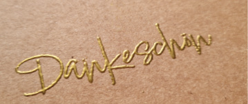 Dankeschön in schöner Schnörkelschrift geschrieben.